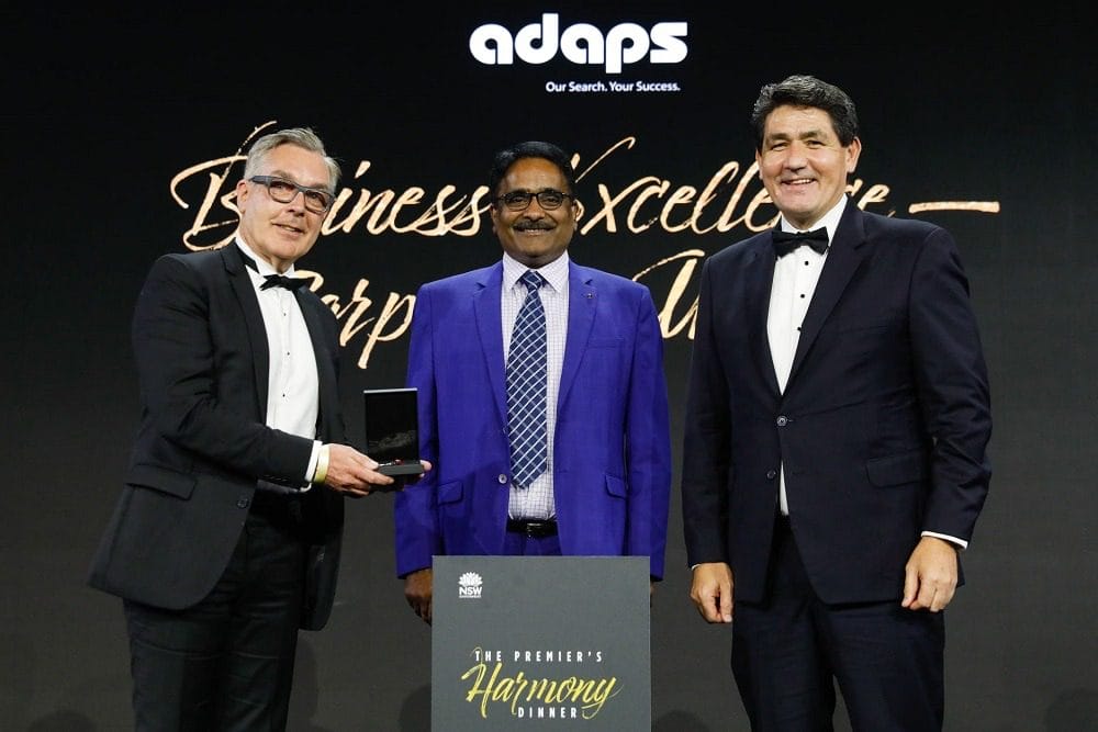 Three men receiving the Premier's Harmony Dinner award