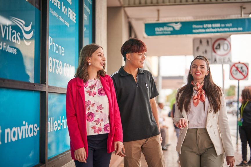 Sanja Nikolic walking outside the Navitas Skilled Futures college with two colleagues 2