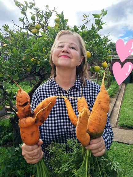 Katarina Yeromina with homegrown carrots