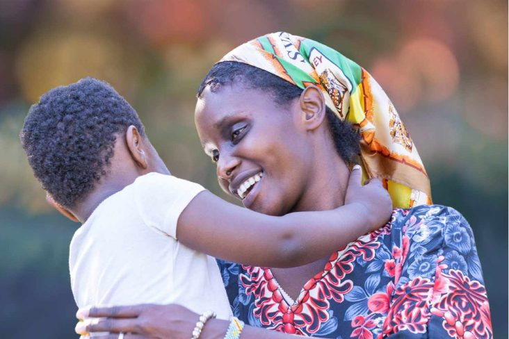 Woman holding a child in her arms and looking in to each other's eyes