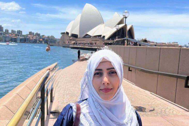 Tanzeem Chaudhary, AMEP student standing at Circular Quay in Sydney with the Sydney Opera House in the background