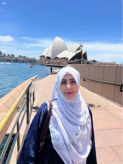 Tanzeem Chaudhary, AMEP student standing at Circular Quay in Sydney with the Sydney Opera House in the background