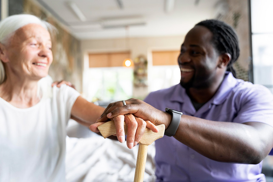 A male care industries student sitting with a mature woman who is using a walking stick (900x600).