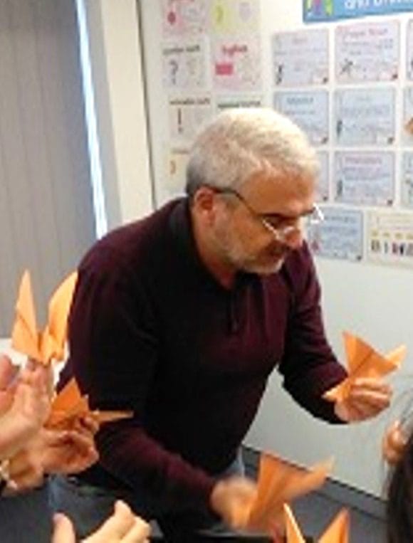Photo of man holding origami