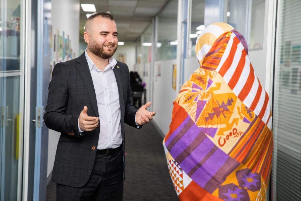 Man talking with woman wearing headscarf