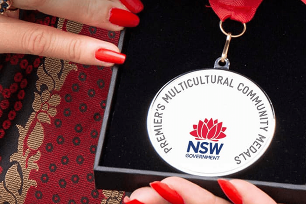 Close up of hand's holding Premiers multicultural community medal