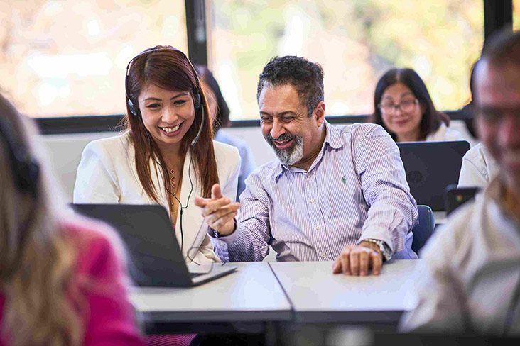 A female student wearing a headset, sitting at a desk with a pathway guidance advisor (732x488).